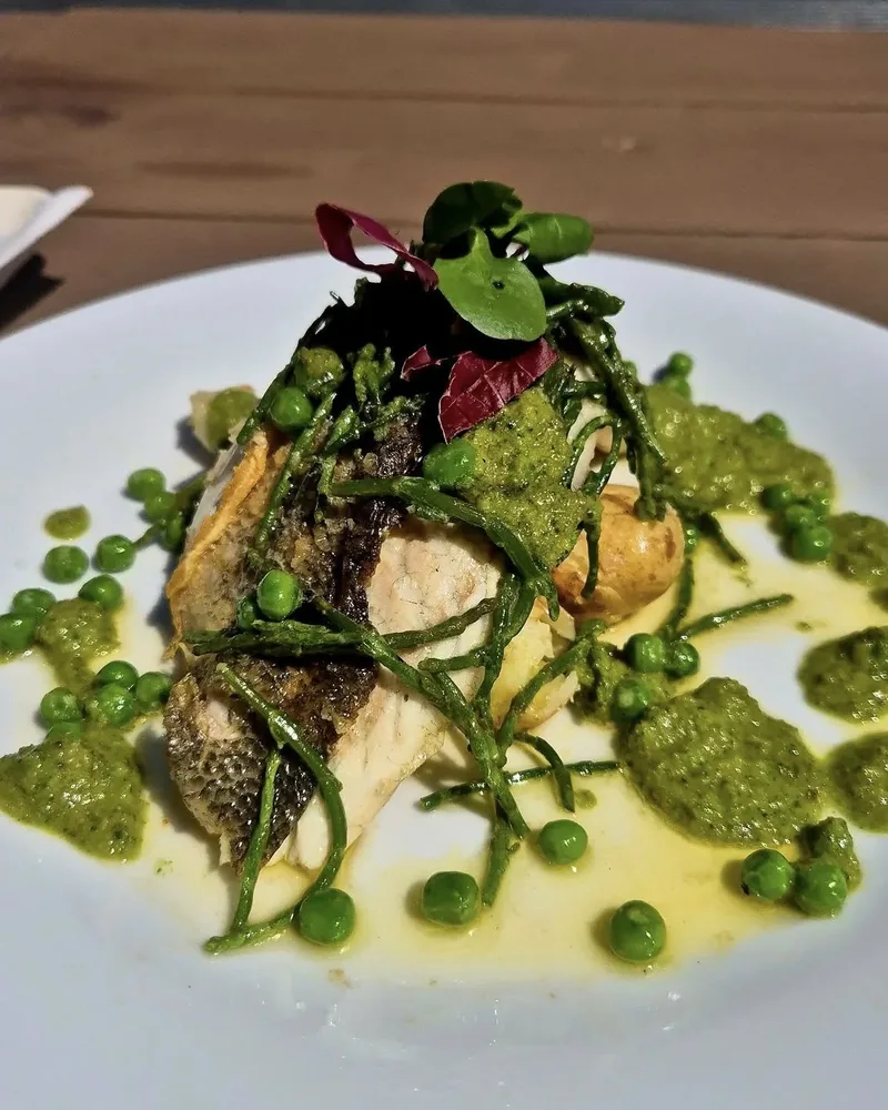 Pan-fried fish with samphire, peas and a herb sauce